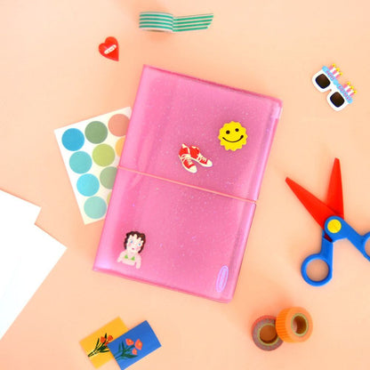 Pink glitter sticker album with sleeves, with small stickers on the cover