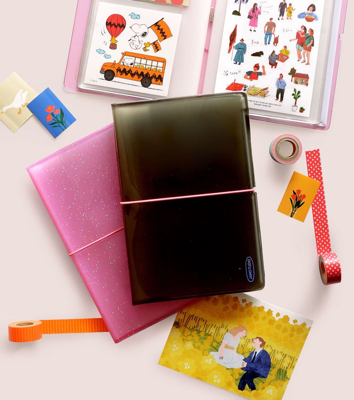 Glitter pink sticker album with sleeves open, showing black interior pages