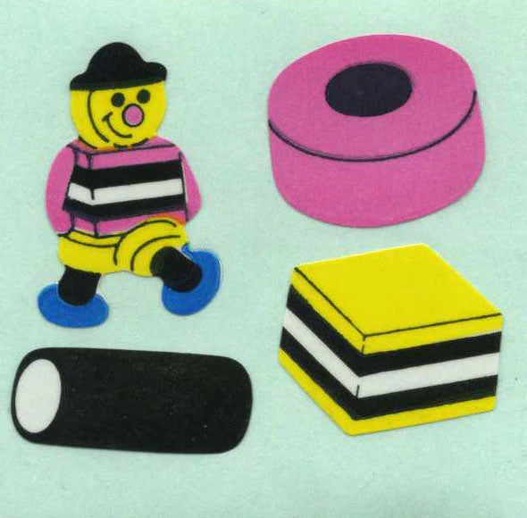 Sticker roll with cartoon figure, stacked book stickers, and dark strip with oval