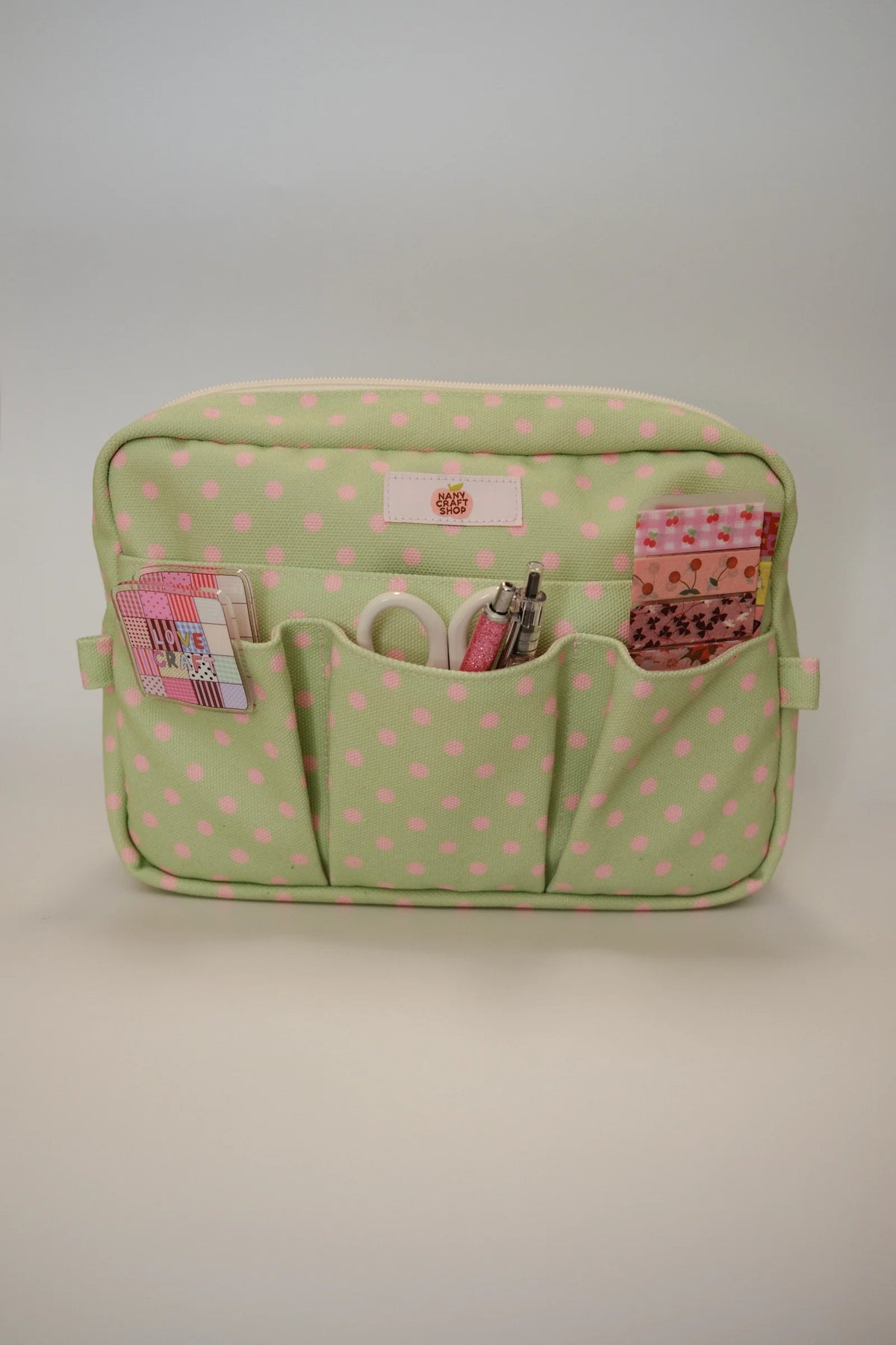 Green polka dot crafting pouch with zipper top and three front pockets