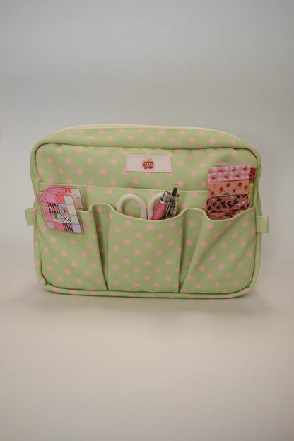 Green polka dot crafting pouch with zipper top and three front pockets