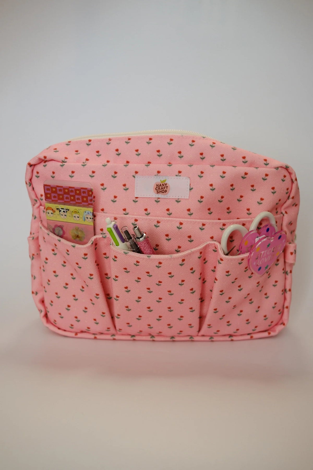 Pink floral crafting pouch with front pockets and zip pull, keyring charm