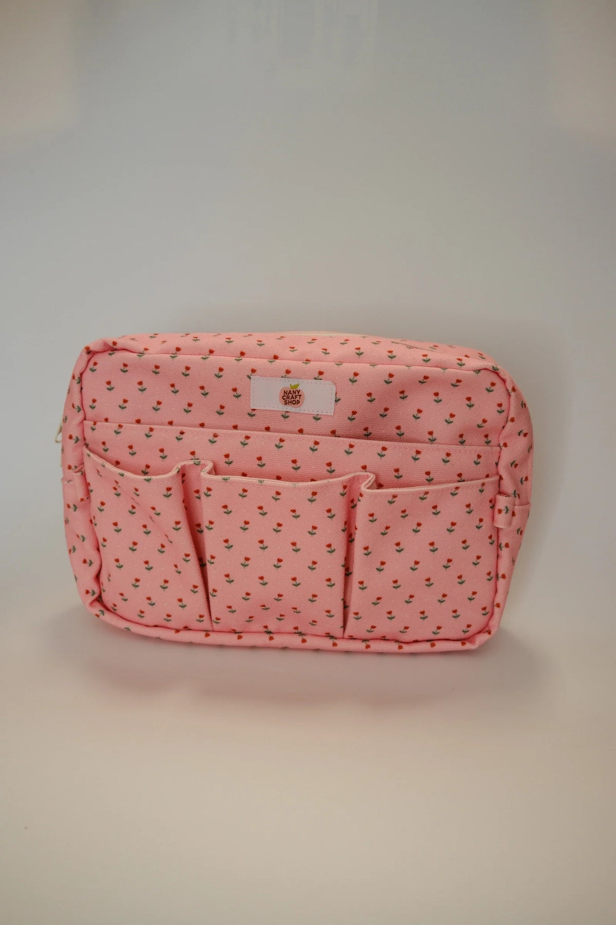 Pink floral crafting pouch with top label patch and front zip sections