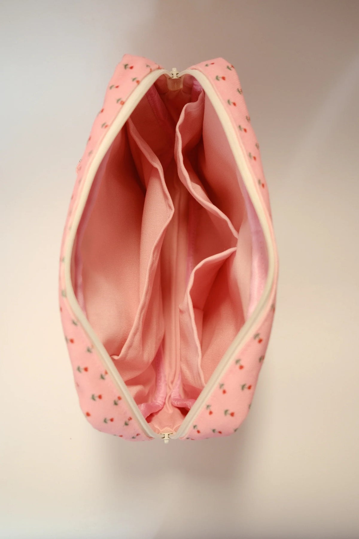 Pink floral crafting pouch open, showing inner lining and elastic divider