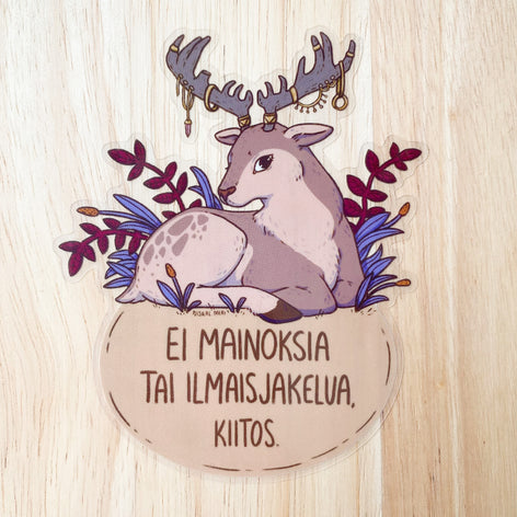 Round vinyl sticker with reindeer illustration, flowers, and Finnish text slogan