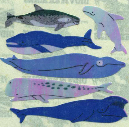Whale sticker roll with pearly finish, featuring assorted blue and purple whale designs